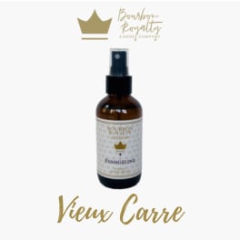 Amber spray bottle with a gold label and crown logo