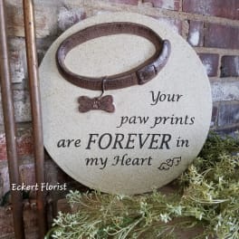 Round memorial plaque with a collar and paw print charm