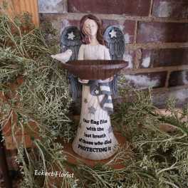 Angel figurine holding a bowl with a small bird beside it