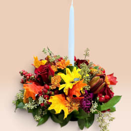 Autumn floral centerpiece with a tall white taper candle