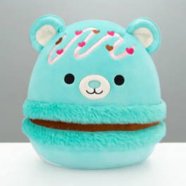 Turquoise plush bear with a smiling face and heart decorations
