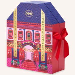 Decorative gift box with a red ribbon and colorful building illustration