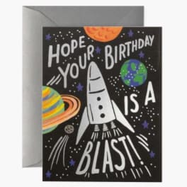 Birthday card with a rocket and planets in space