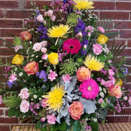 Large mixed bouquet with roses, gerbera daisies, and purple blooms