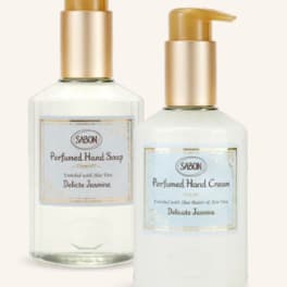 Two pump bottles of scented hand soap and hand cream