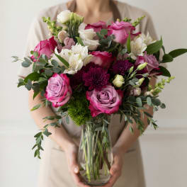 Bouquet of pink and white roses with white alstroemeria in a glass vase