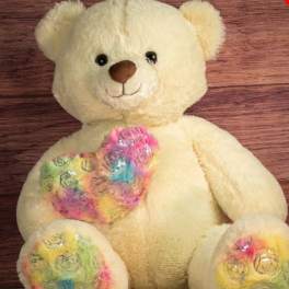 Cream teddy bear with colorful floral-patterned paws and chest