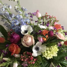 Mixed bouquet with pastel and bright flowers including roses and anemones