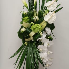 Tall white floral spray with calla lilies, orchids, and anthuriums