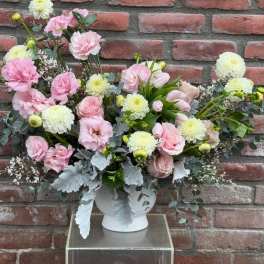 Pink and white floral arrangement in a white vase