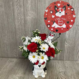 Red roses and white daisies in a dog-shaped vase with a heart balloon.