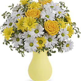 Yellow roses and white daisies in a yellow vase
