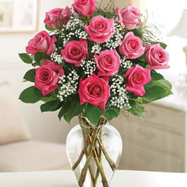 Pink roses arranged in a clear glass vase
