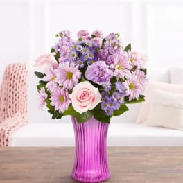 Pink and lavender mixed bouquet in a tall purple vase