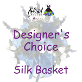 Silk flower basket with blue and white blooms and a ribbon