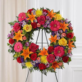 Colorful floral wreath on a black easel stand
