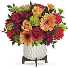 Mixed bouquet of roses, gerbera daisies, and chrysanthemums in a white vase