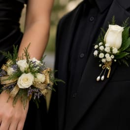 White rose boutonniere and matching wrist corsage on black formalwear