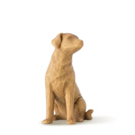 Wooden dog figurine sitting on a white background