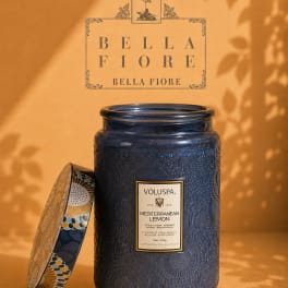 Blue scented candle in a decorative glass jar with lid