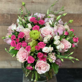 Bouquet of pink and white roses with bright pink spray roses