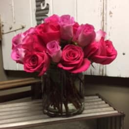 Bouquet of bright pink roses in a glass vase