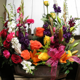 Colorful mixed flower arrangement in a wooden container