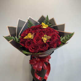 Bouquet of red roses with butterfly picks and a red ribbon