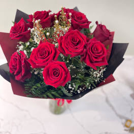Bouquet of red roses with a small gold crown topper