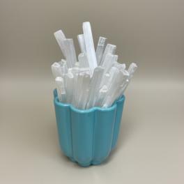 Blue cup holding white crystal-like sticks