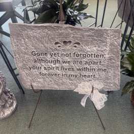 Memorial stone plaque on a metal stand with a ribbon bow