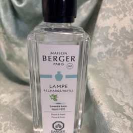 Clear bottle of Maison Berger Paris lamp refill with a black cap