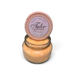 Jar candle with a round lid labeled Tyler Candle Company