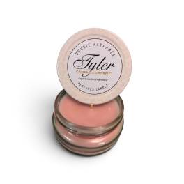 Pink scented candle in a glass jar with a round lid