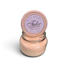 Peach scented candle in a glass jar with a round lid