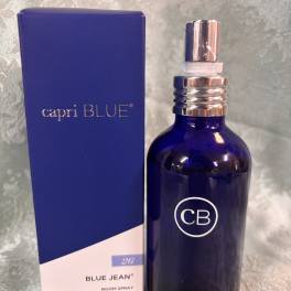 Blue room spray bottle beside its matching box