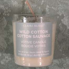 Glass votive candle labeled Wild Cotton Cotton Sauvage