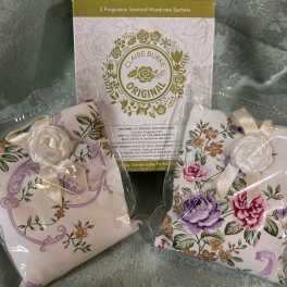 Packaged floral wardrobe sachets with ribbon ties and printed fabric covers