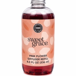 Bottle of pink flower diffuser refill with a peach label