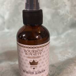 Amber bottle of White Linen room spray with a black pump top