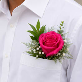 Hot pink rose boutonniere pinned to a white dress shirt