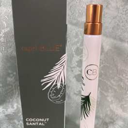 A small perfume spray bottle beside its box.
