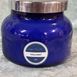 Blue glass candle jar with a silver lid and label