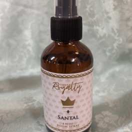Amber room spray bottle with a black pump and pink label