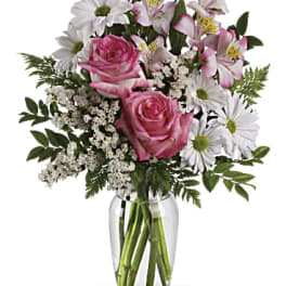 Pink roses and white daisies with alstroemeria in a glass vase