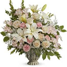 Bouquet of white lilies, cream roses, and pink carnations in a decorative vase
