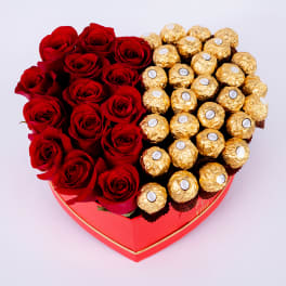 Heart-shaped box with red roses and gold-wrapped chocolates