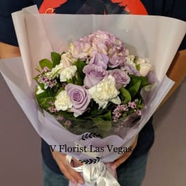 Lavender and white bouquet wrapped in translucent paper