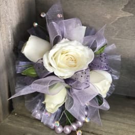 Small bouquet of white roses with lavender ribbon and bead accents