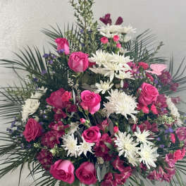 Pink roses and white daisies in a large standing arrangement